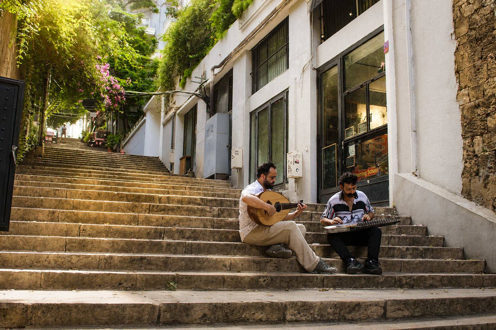 Daraj: Camille and Oussama playing qanun and oud on stone stairs in Beirut